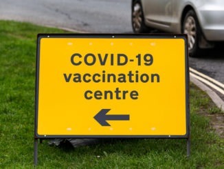 COVID-19 vaccination centre road sign on a street