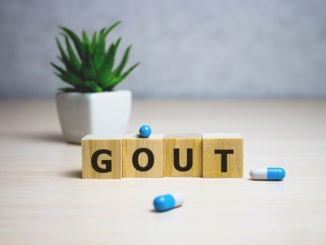 diagnosis – gout. word on wooden cubes, background. Selective focus. Medical concept.