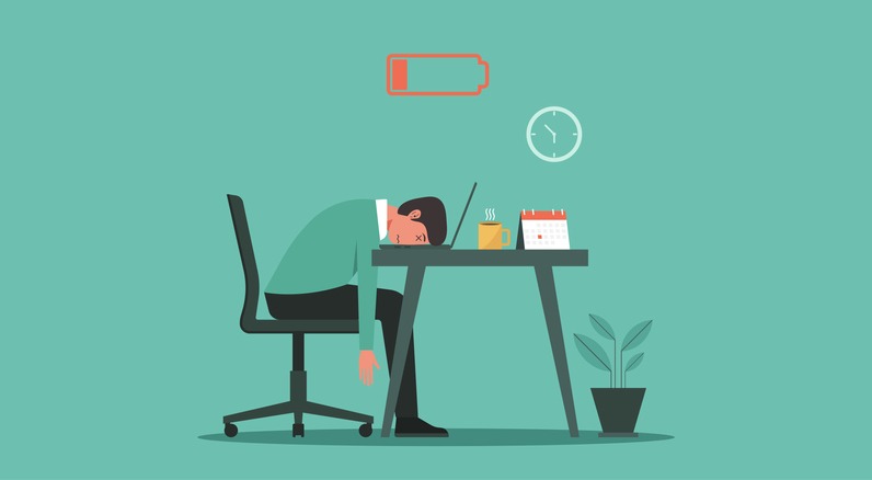 burnout syndrome concept. Tired man with low energy battery working on laptop in workplace