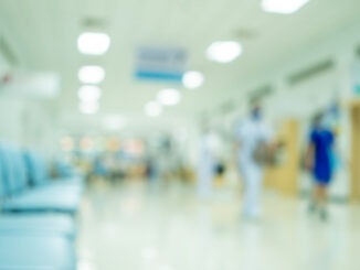 Defocussed nurse in hospital background