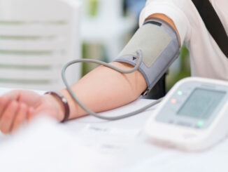 Doctor checking patient arterial blood pressure in hospital