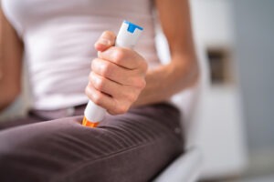 Woman using Auto Epinephrine Injector