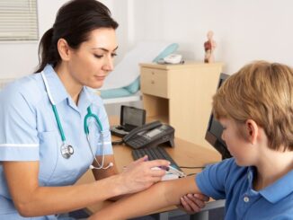 General practice nurse with young boy