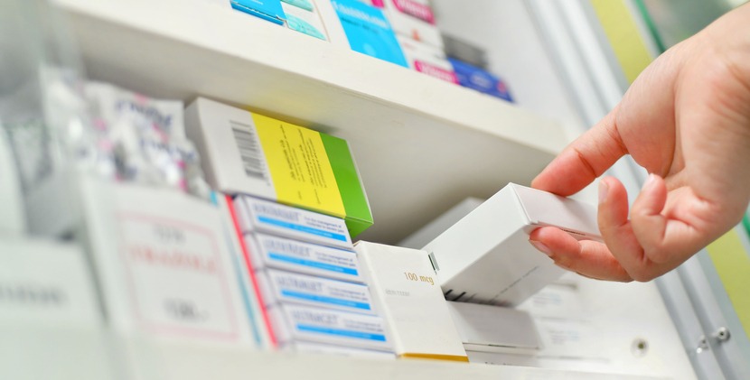 Closeup pharmacist hand holding medicine box