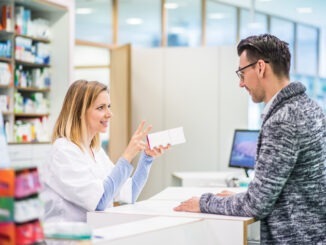 Female pharmacist serving a male customer