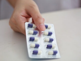 Close up of female doctor hands holding pills