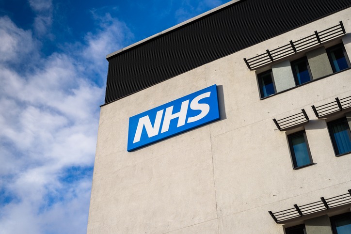 View of a NHS (National Health Service) logo on the outside of a building