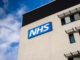 Image of hospital building with NHS sign outside