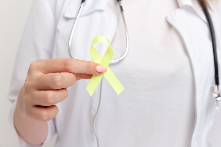 Yellow ribbon in doctor's hand to signify suicide prevention