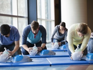 Group of people learning CPR