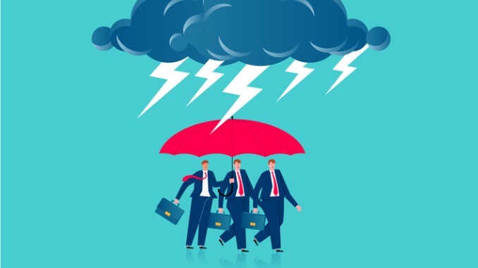 Businessmen under umbrella to protect themselves against a storm