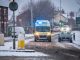 NHS EMAS Ambulance Service on 999 emergency response with snow on road blue lights during snowfall