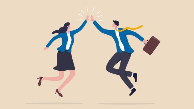 happy businessman and woman teamwork coworkers jumping and hi five clapping hands.