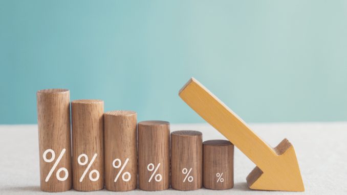 Wooden blocks with percentage sign and down arrow, financial recession crisis, interest rate decline, risk management concept