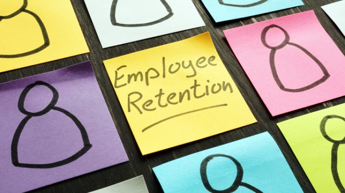 Employee retention sign and figurines on the memo sticks.
