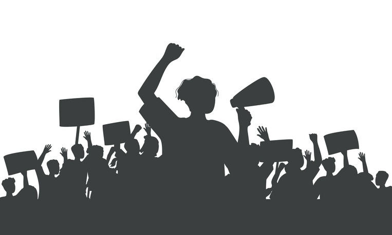 Silhouette of protesting man with loudspeaker and crowd of people with raised hands and banners