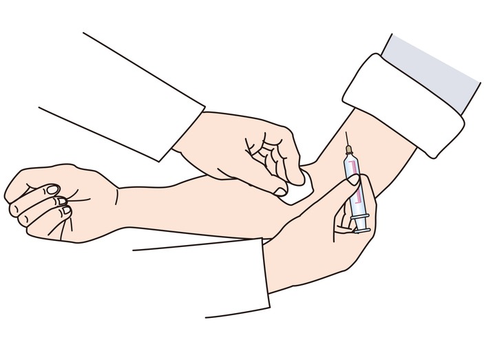 Doctor disinfecting patient's arm and about to give injection