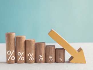 Wooden blocks with percentage sign and down arrow, financial recession crisis, interest rate decline, risk management concept