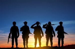 Silhouettes of a soldiers against the sunset
