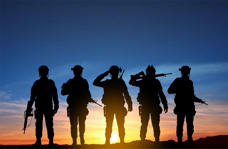 Silhouettes of a soldiers against the sunset