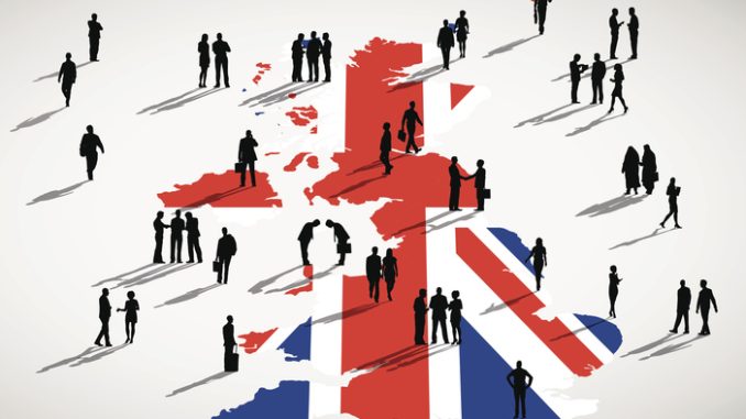 Silhouettes of business people on UK map