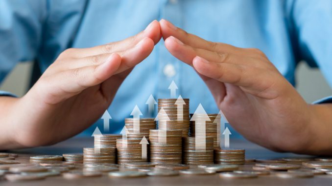 Stacked coins is protected by human hand