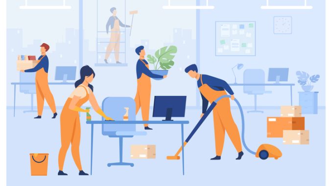 Professional janitors working in office 