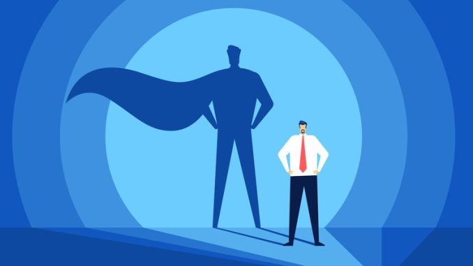 Businessman with superhero shadow. 