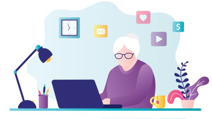 Old business woman works on computer 