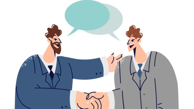 Handshakes of two white collar workers with dialogue clouds entering into partnership agreement