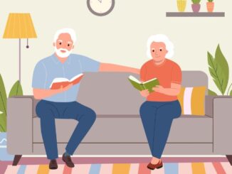Elderly woman and man sitting on the sofa with books at living room