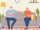 Elderly woman and man sitting on the sofa with books at living room