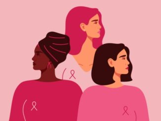 Three women with pink ribbons of different nationalities standing together.