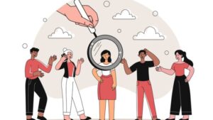 Hand with magnifying glass points to young woman. Successful Entrepreneur or Businesswoman.