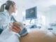Shot of the Doctor does Ultrasound / Sonogram Procedure to a Pregnant Woman.