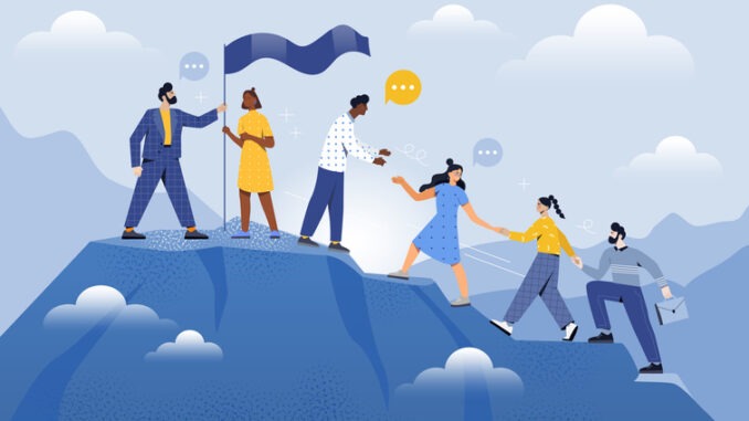 Male and female coworkers are helping each other to climb up the mountain together. Teamwork partnership. Company employee challenge to climb to mountain together.