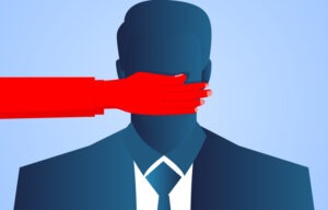 Businessman's mouth is blocked by red hands
