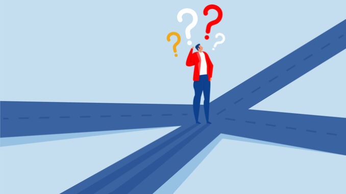 confusing businessman looking at multiple road with question mark and thinking which way to go. irection, choosing options or multiple path, make decision for career path