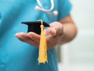 Asian doctor study learn with graduation gap hat in hospital ward, clever bright genius education medicine concept.