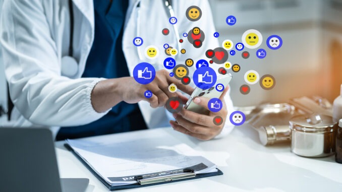 doctor are using smartphonet to Social media at morning light.