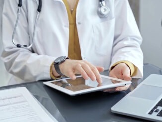 Doctor at work. Medical professional using tablet in clinic office. Medicine and health care concept.