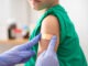 Vaccine and plaster on the arm of a child patient in a hospital for an injection or healthcare.Nurse, medical and insurance with a child in a clinic for his vaccination.