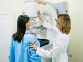 NEWS: Breast Screening Hits 10-Year High Young woman is having mammography examination at the hospital or private clinic with a professional female doctor.