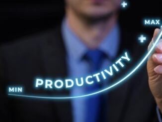 NEWS: NHS England Targets 2% Productivity Gains Businessman drawing rising productivity at work graph from minimum to maximum