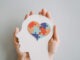 Hands holding jigsaw puzzle heart shape in brain Autism awareness, neurodiversity concept, World Autism Awareness Day