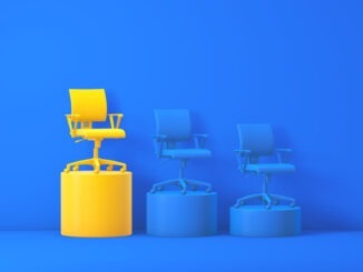 3D render: a yellow office chair stands on the tallest yellow podium in a blue studio, flanked by two lower blue chairs—bold contrast symbolizing leadership and career growth.