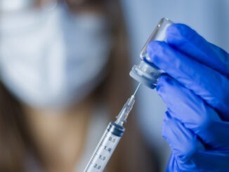 Vaccine in researcher hands, female doctor holds syringe and bottle with vaccine for coronavirus cure. Concept of corona virus treatment, injection, shot and clinical trial during pandemic.