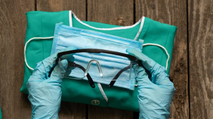 medical uniform set folded on an isolated background nurse