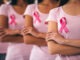 Cropped image of group of young multiracial woman with pink ribbons are struggling against breast cancer. Breast cancer awareness concept.