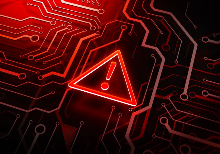 Cybersecurity Alert: A stark, illuminated warning symbol is the centerpiece of a network circuit, vividly conveying the critical essence of a data breach.